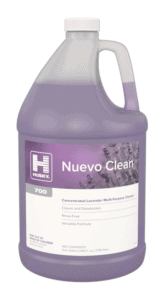 A large plastic jug of Husky Nuevo Clean 700, a lavender multi-purpose cleaner, with a lavender-colored liquid inside and a label featuring lavender flowers.