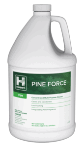 A gallon jug of Husky Pine Force concentrated multi-purpose cleaner with a green label, displaying product details and safety warnings on the front.