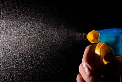 a fine mist of disinfectant is squirted out of a spray bottle