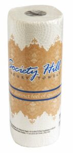 A roll of Kitchen Roll Towel 30/85 stands upright. The packaging is tan and white with blue and white text, reading “The distinct feel of quality.” The roll appears unused and fully wrapped.